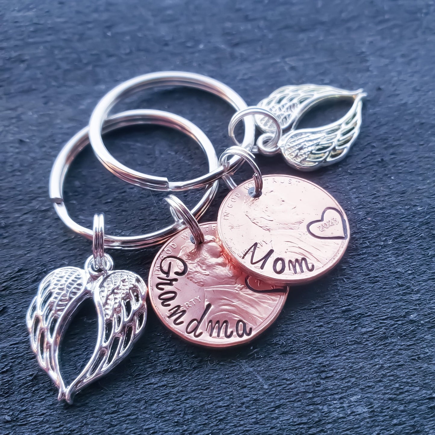 Penny from heaven keychain with double angel wing charm, personalized with name along curve of penny