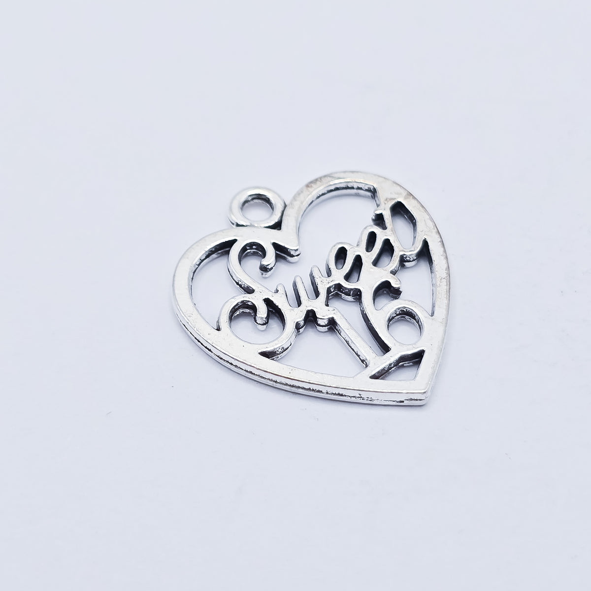 silver heart with sweet 16 in the middle
