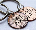2 penny keychains with couples initials and anniversary date stamped, heart stamped around the penny year